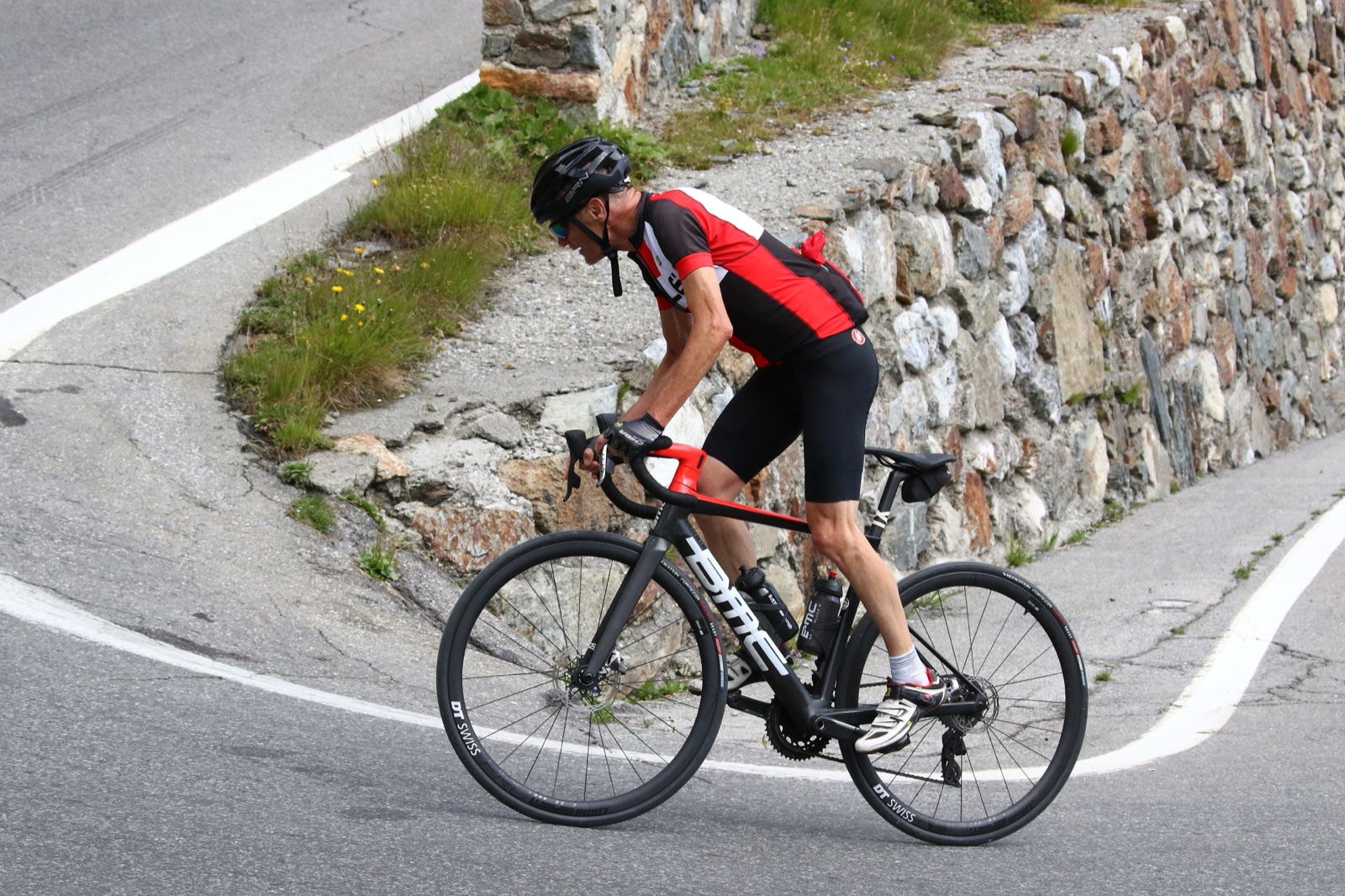 A cyclist on a Stelvio Pass switchback