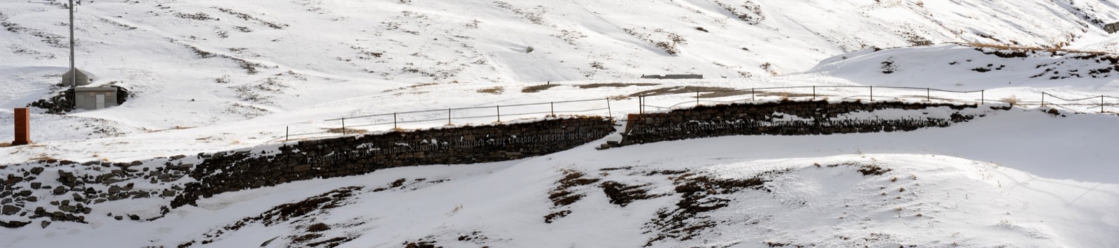 The Furka Pass summit still under snow in winter, Goethe memorial wall visible